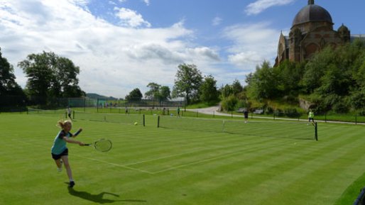 Girl tennis play on the grass courts of Yorkshire Tennis Camp